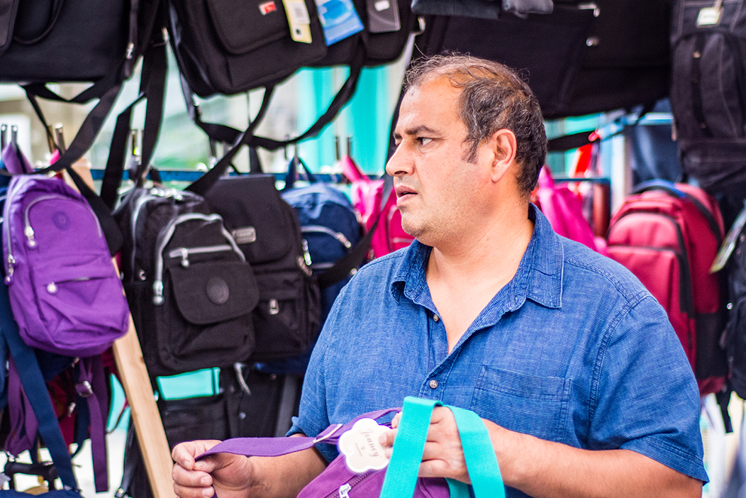 older worker selling bags