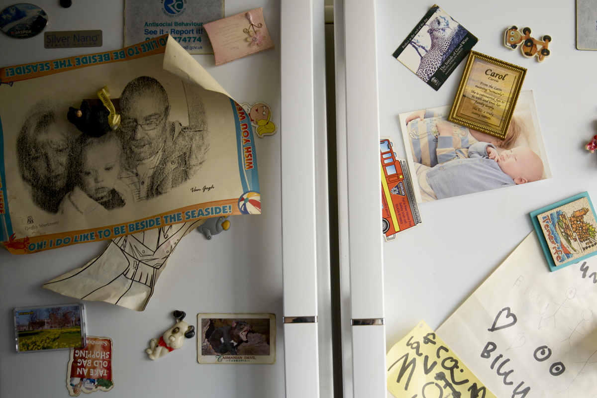 Family fridge covered in photos and magnets