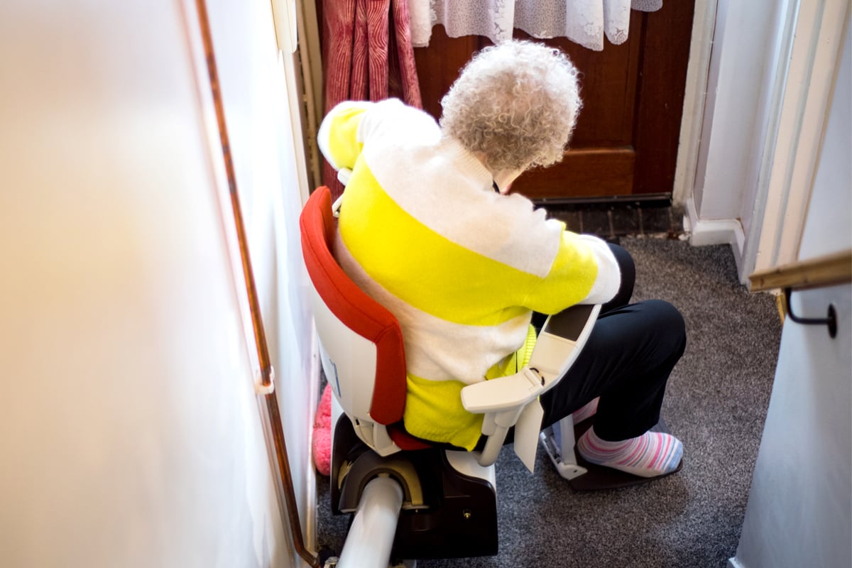 Older woman using a stairlift