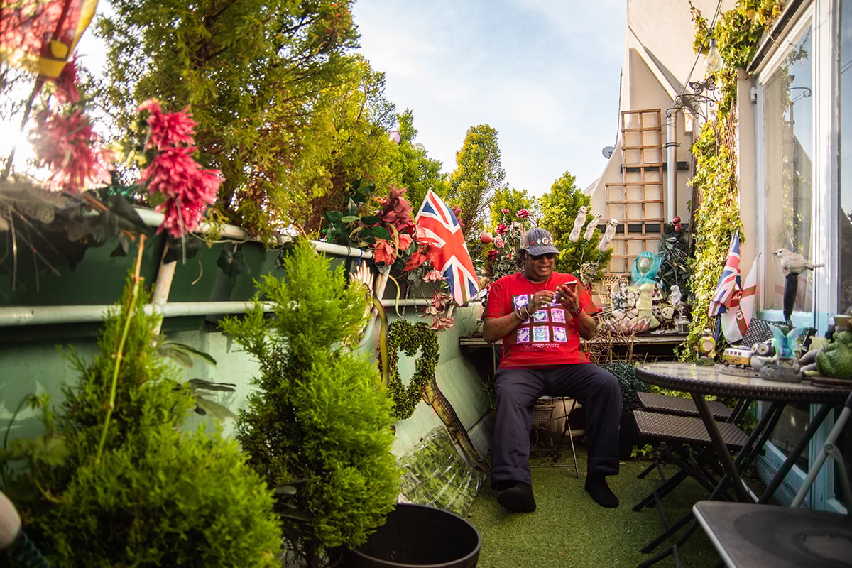 Older man in garden using mobile phone