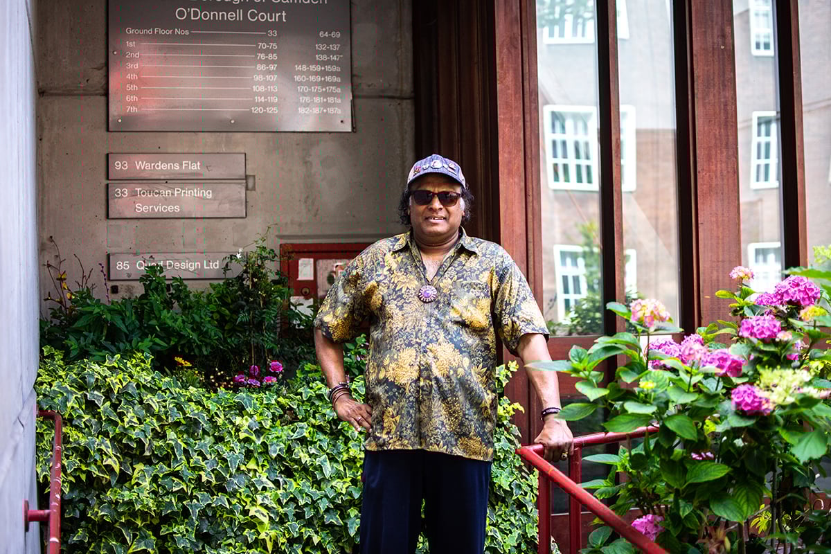 Older man standing outside in his community.