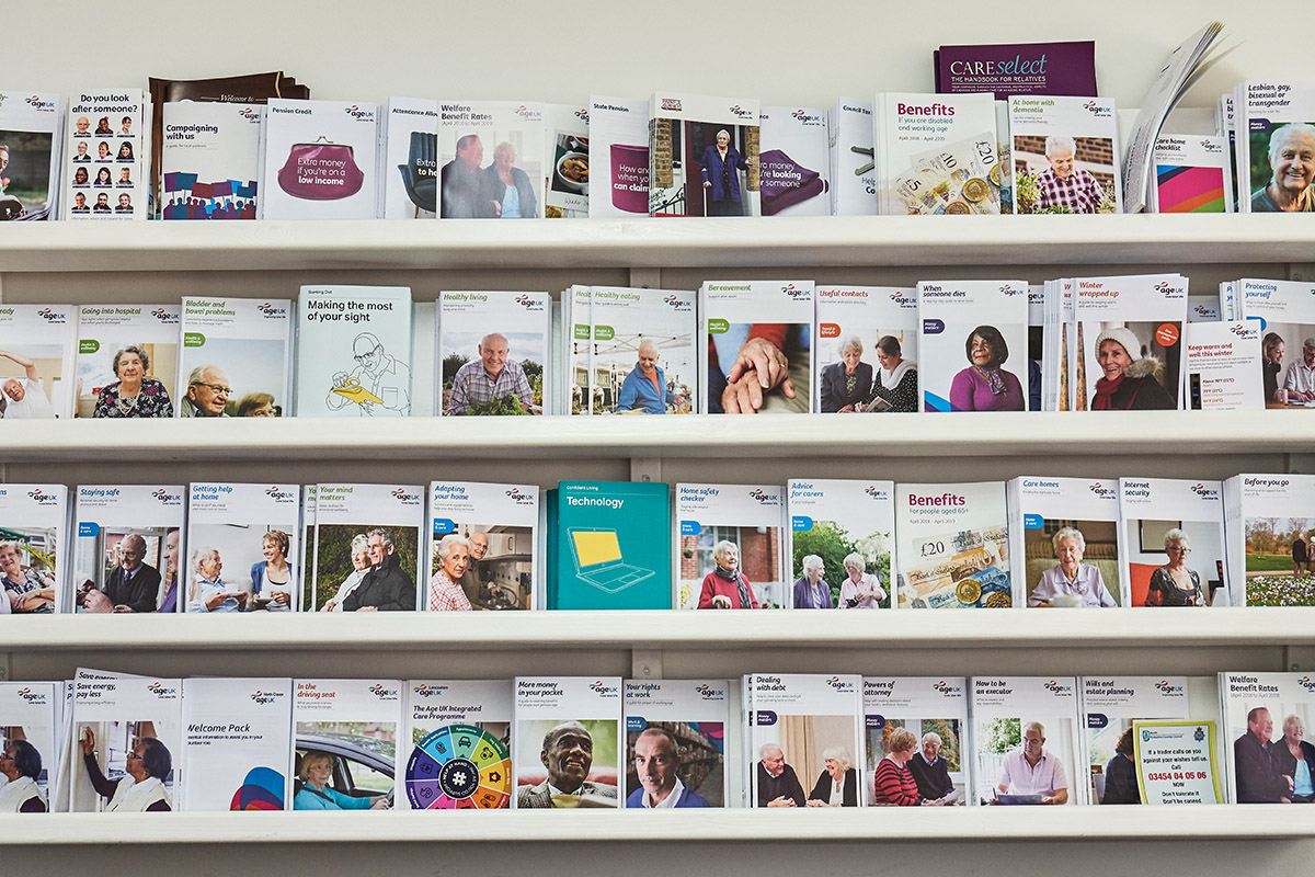 Racks along wall with publications.
