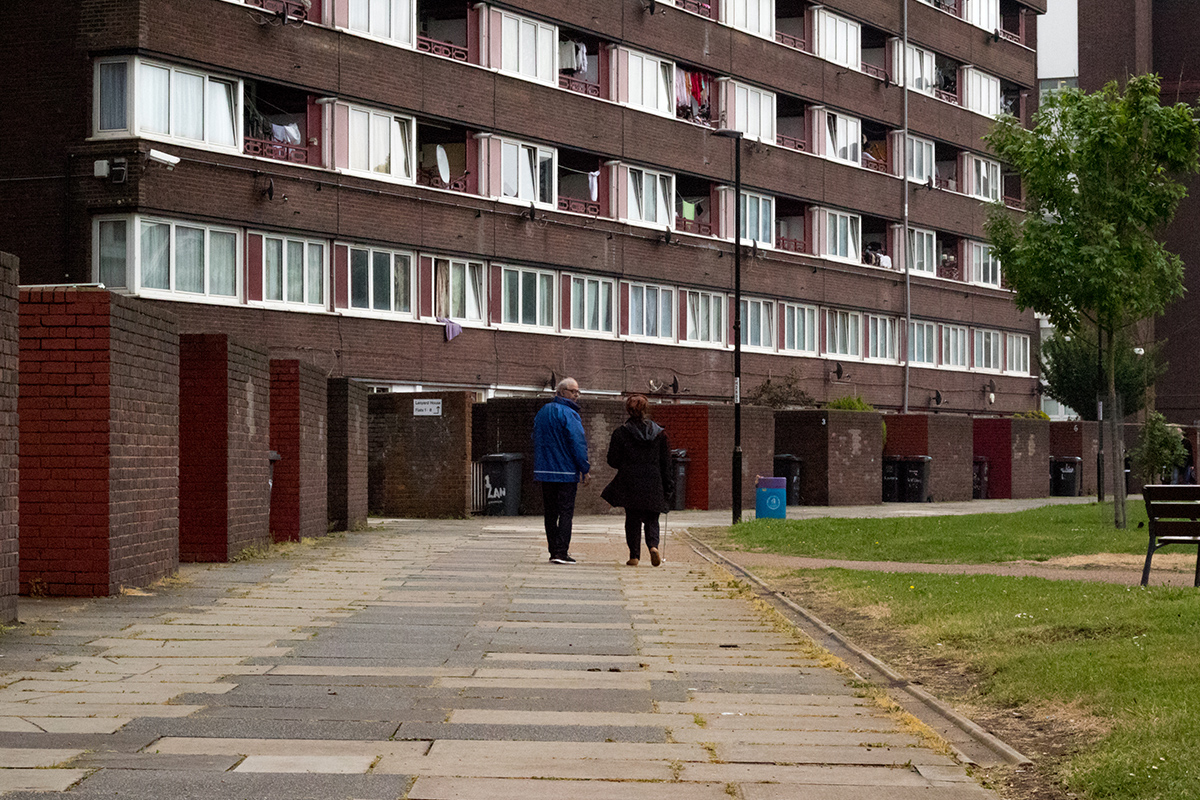 Man and woman walking on an estate.
