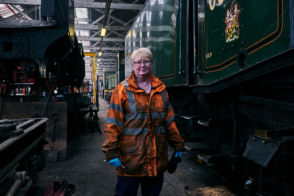 Older woman standing by railway