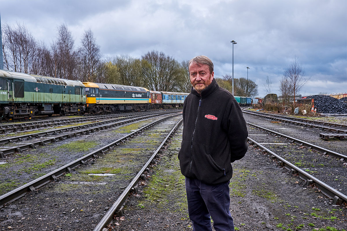 Man standing in front of train