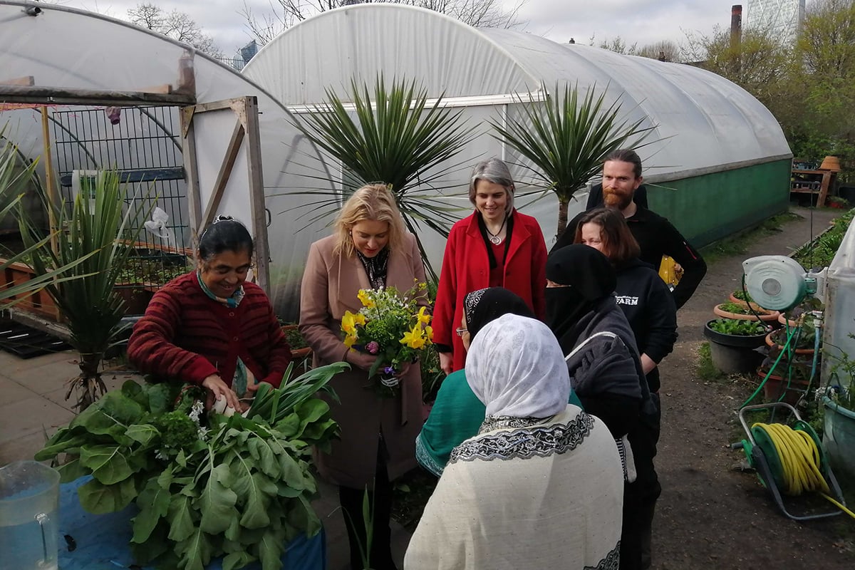 Anna Dixon, Mims Davis and a Sustain volunteer around a garden allotment
