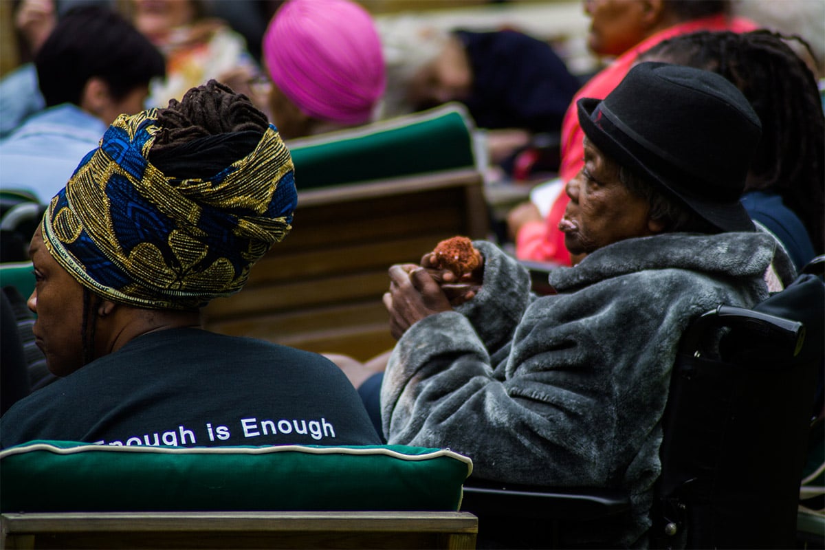 Two women sitting in chairs outside