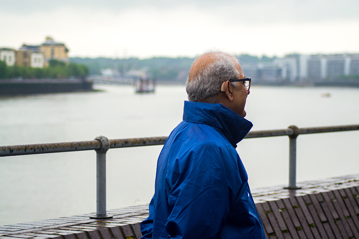 British Asian man looking onto the river