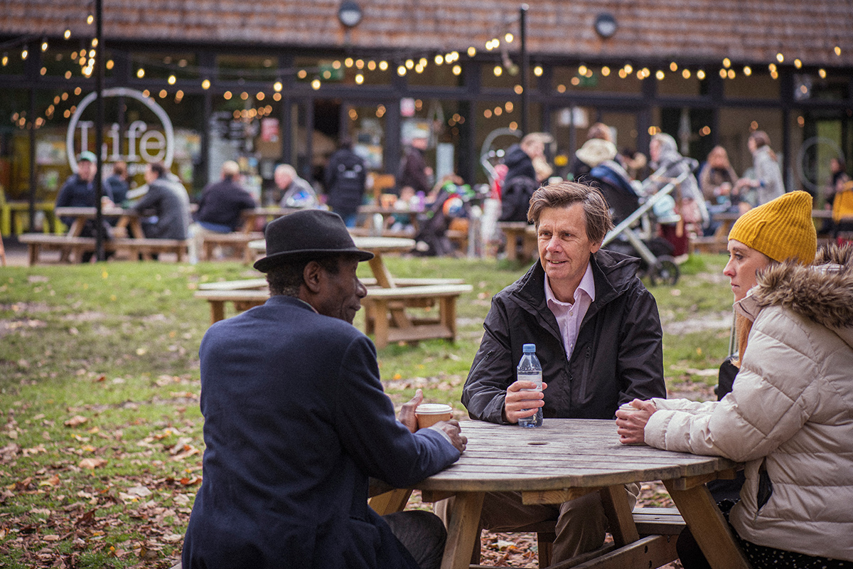 Group of people talking by a table