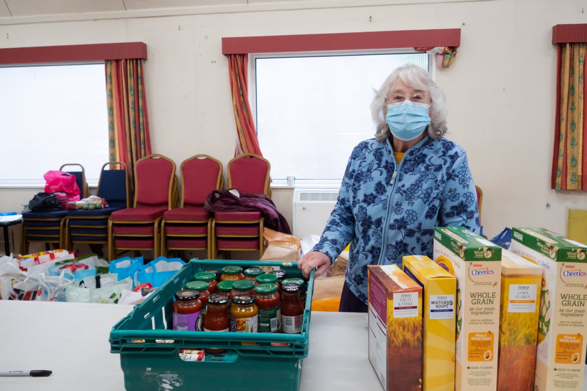 Older woman volunteering at a food bank