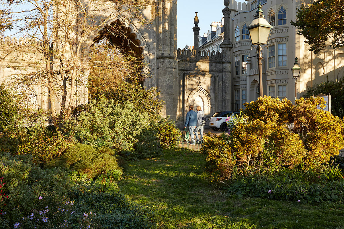 A pair of people walking by a church