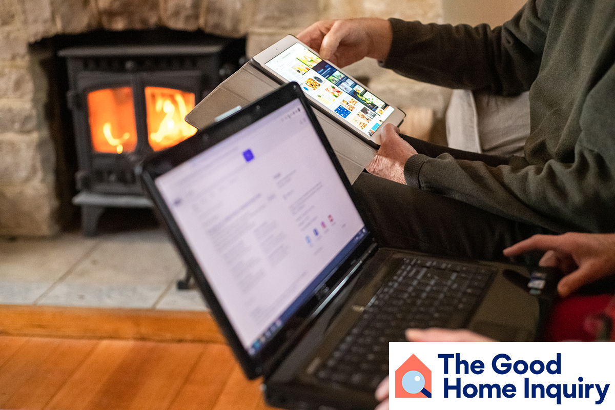 Older couple interacting with tablet and laptop