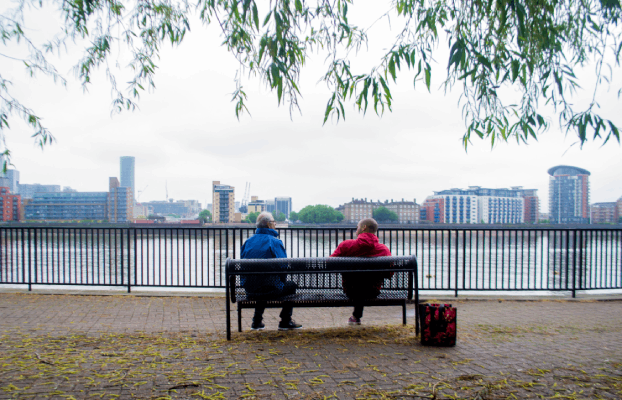 Two BAME people sitting on a bench