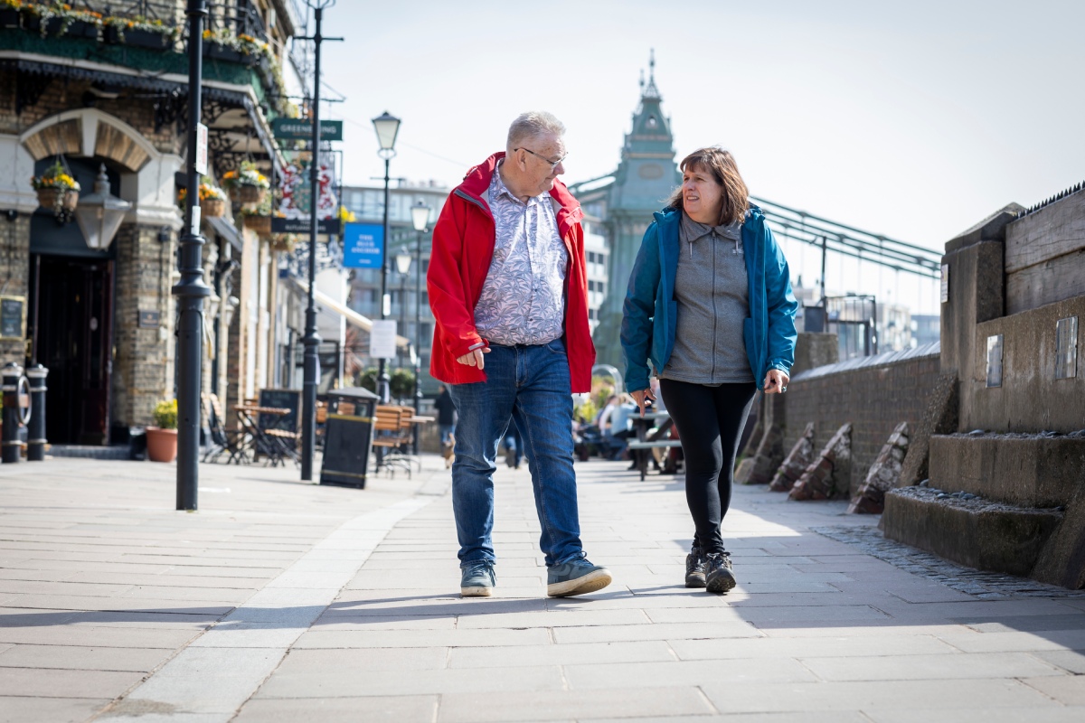 older man and woman walking down the street