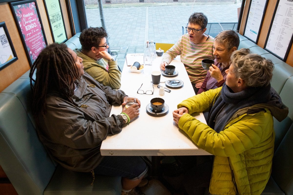 Group of older women sat together and talking