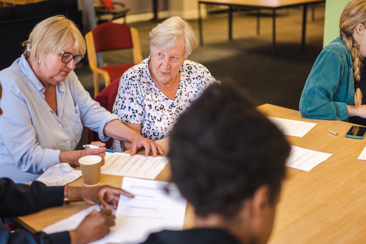 Group of older people sitting together and chatting