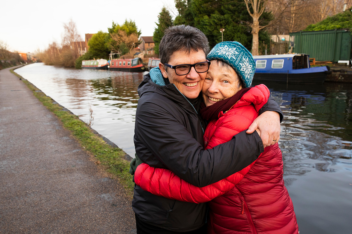 An older couple hugging each other