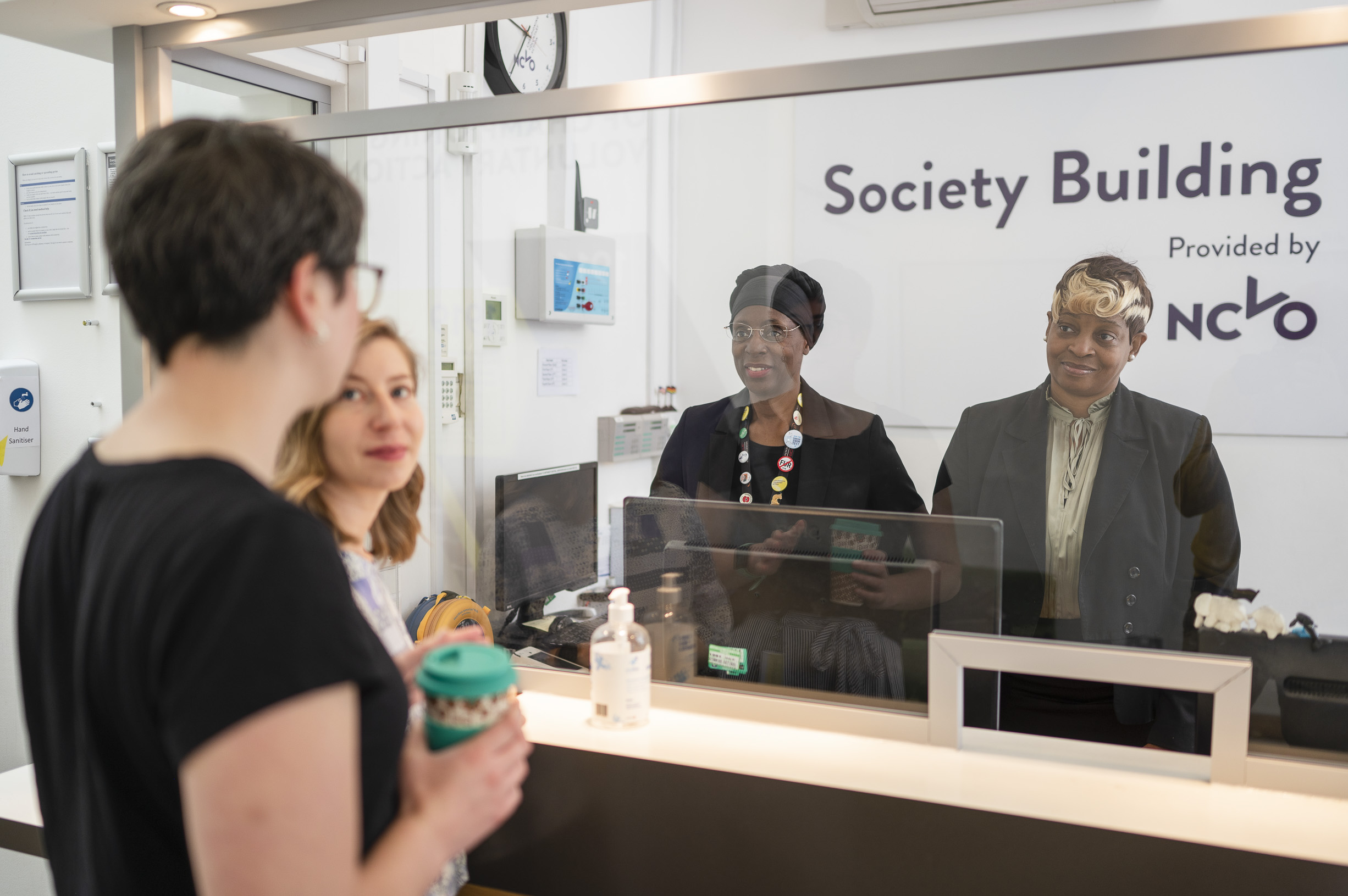 Four employees at an NCVO office are talking together