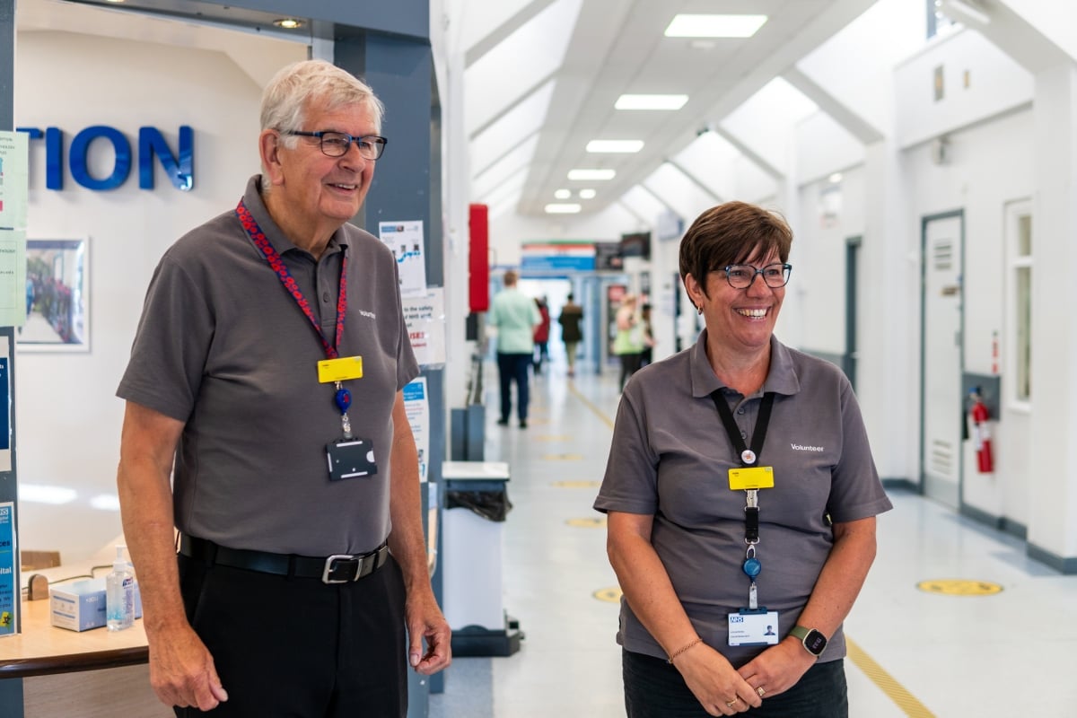 Two older volunteers in a hospital