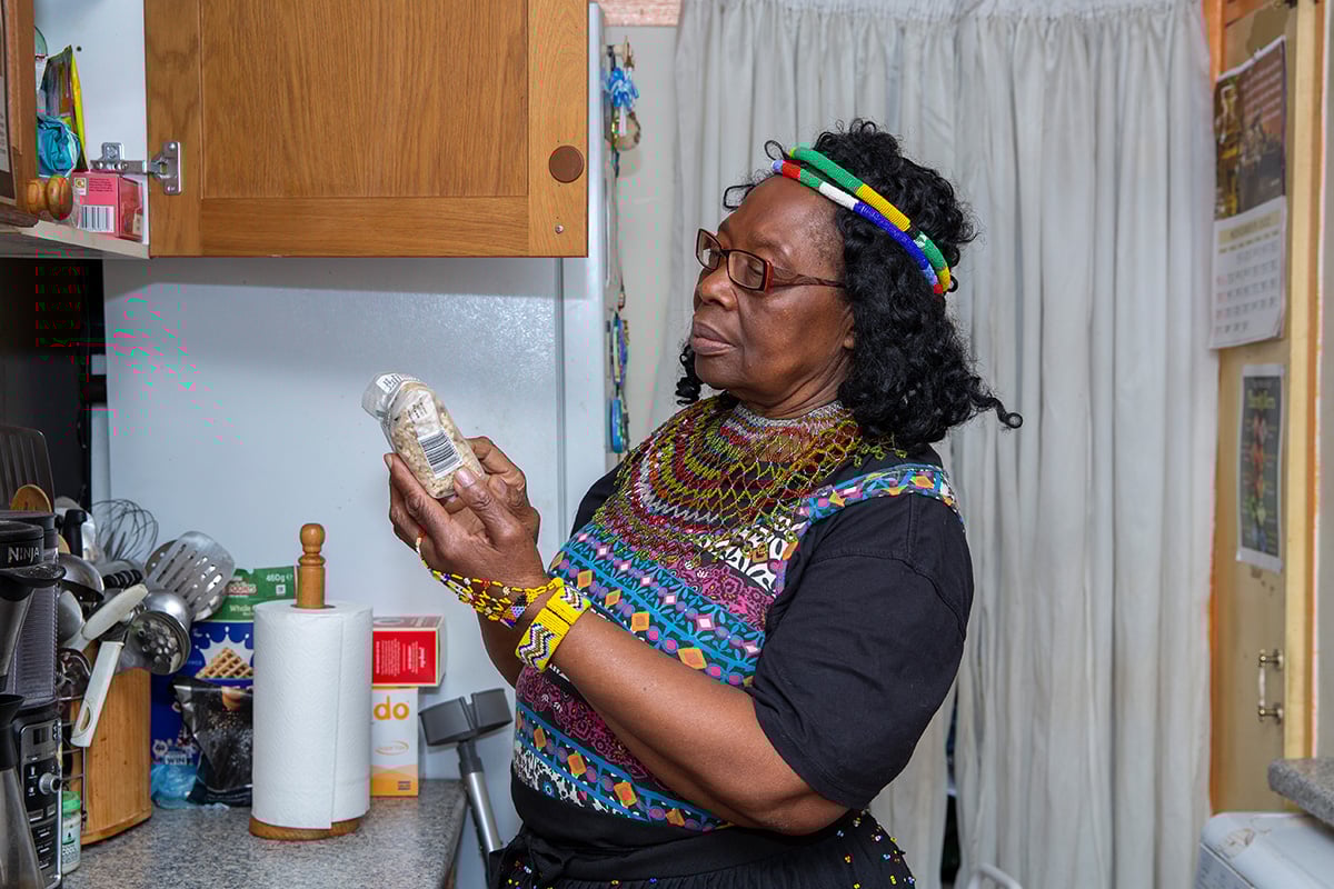 Older woman in kitchen looking at ingredients