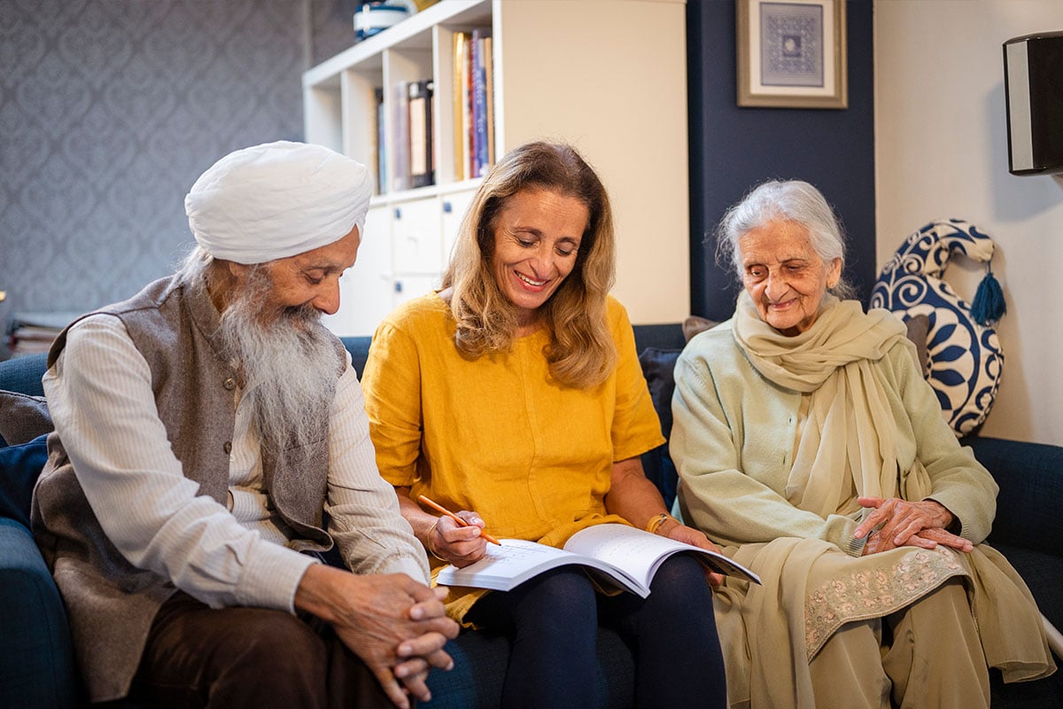 Three older people on a sofa