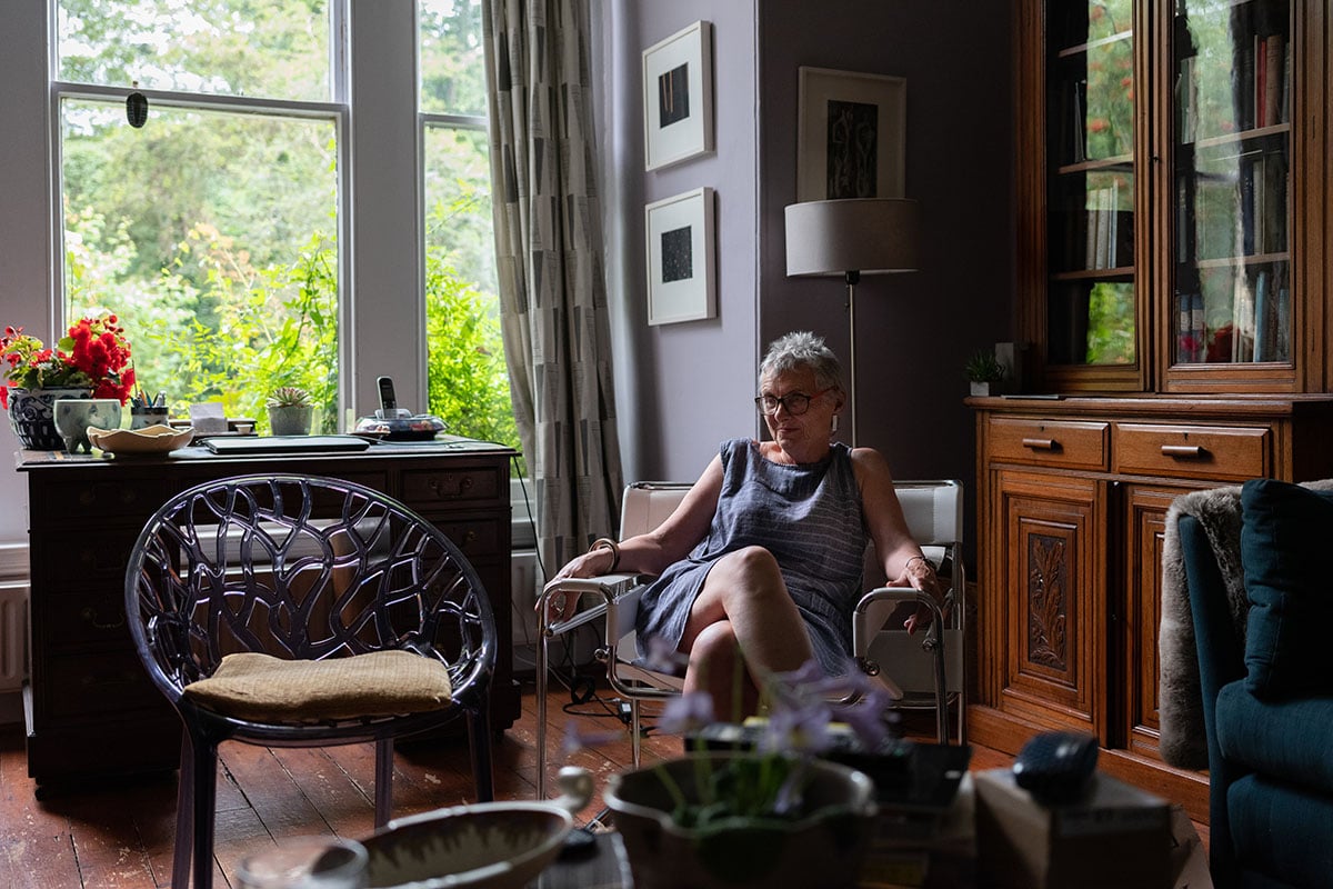 Older woman sat at home