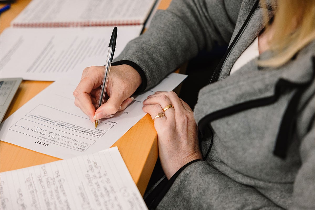 Person-writing-on-paper