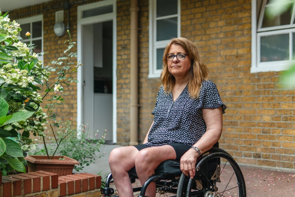 Older woman in a wheelchair looking at the camera