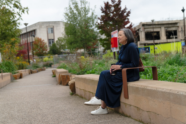An older woman sitting on a bench