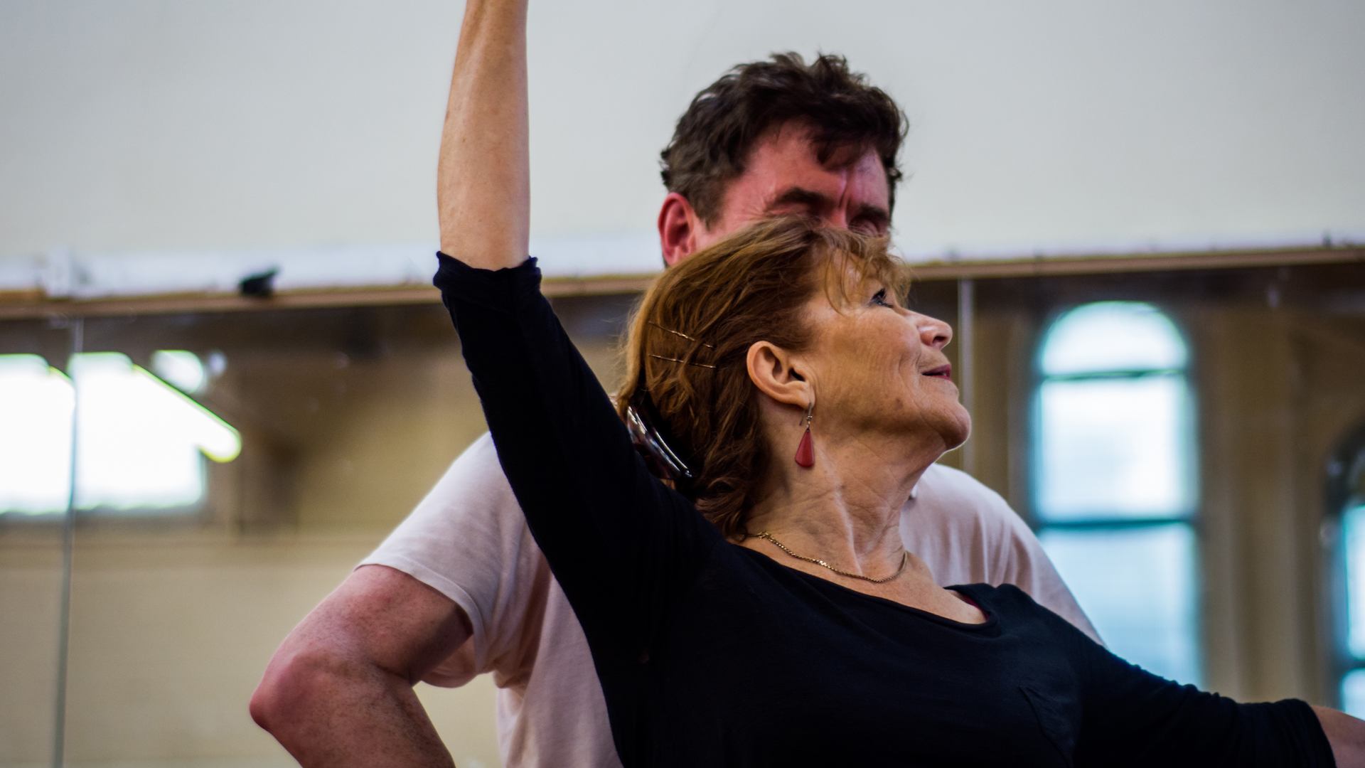 Older woman doing ballet with instructor.