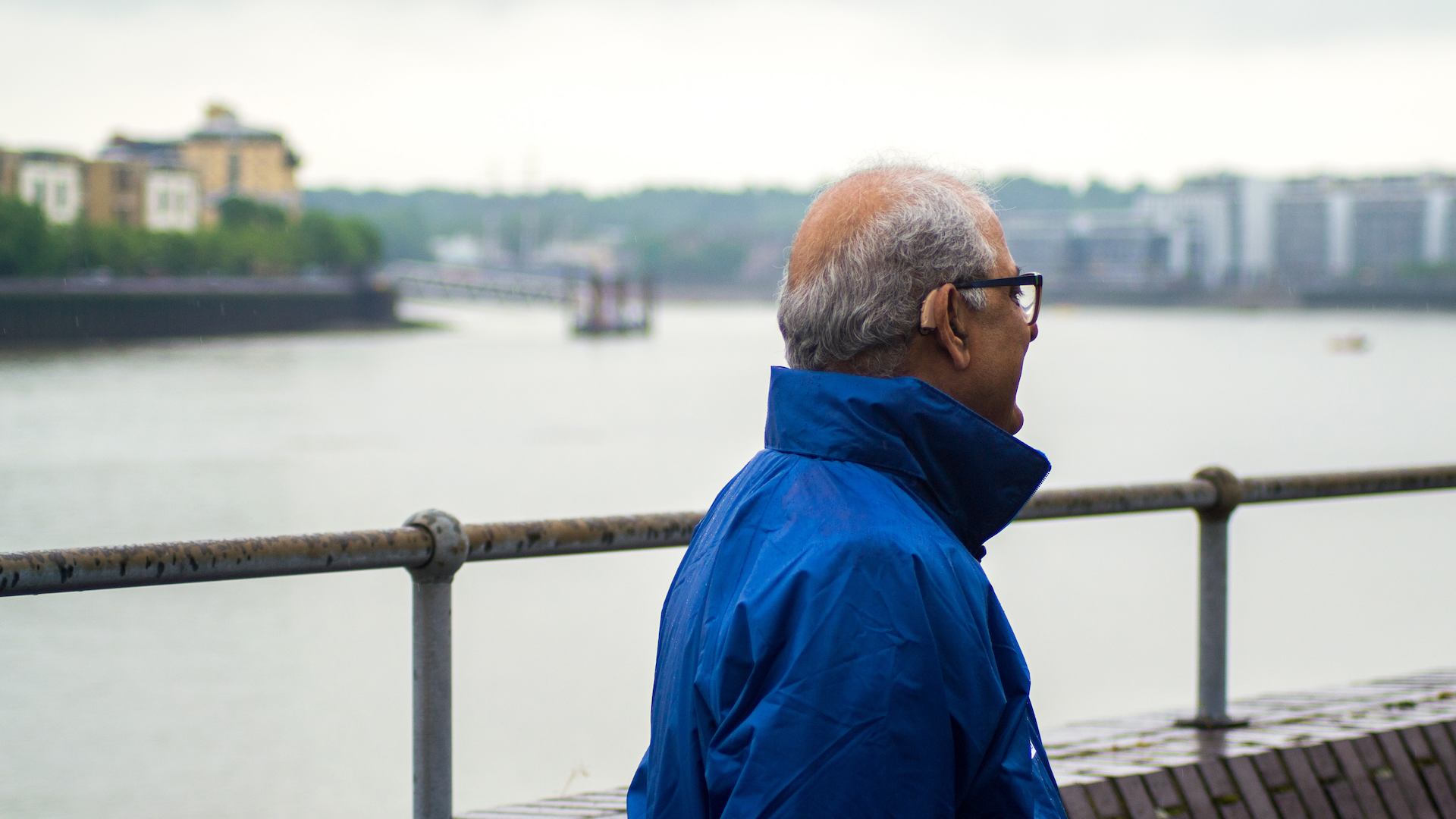 British Asian man looking onto the river