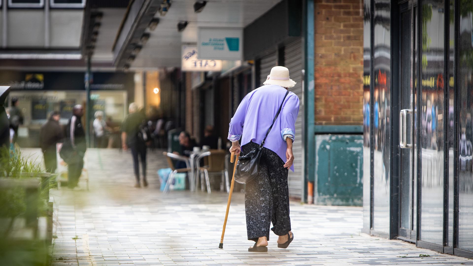 Older person walking on high street