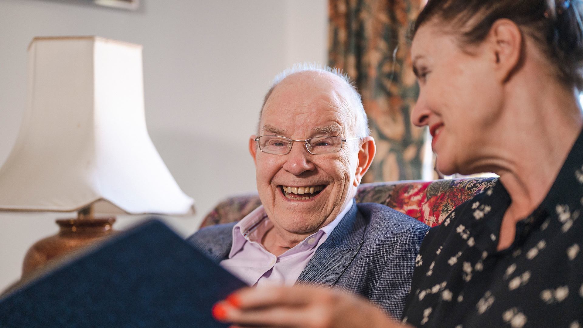 older man and woman reading together
