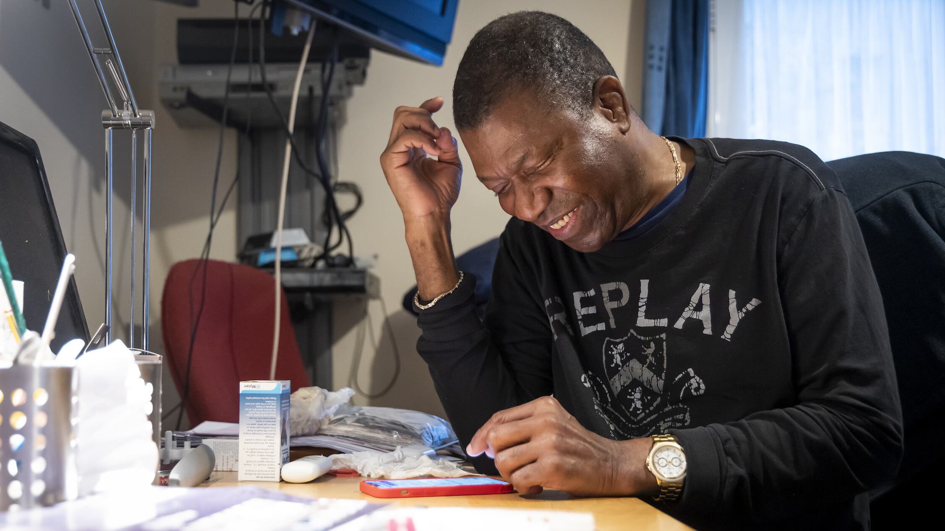 Man smiling at his phone