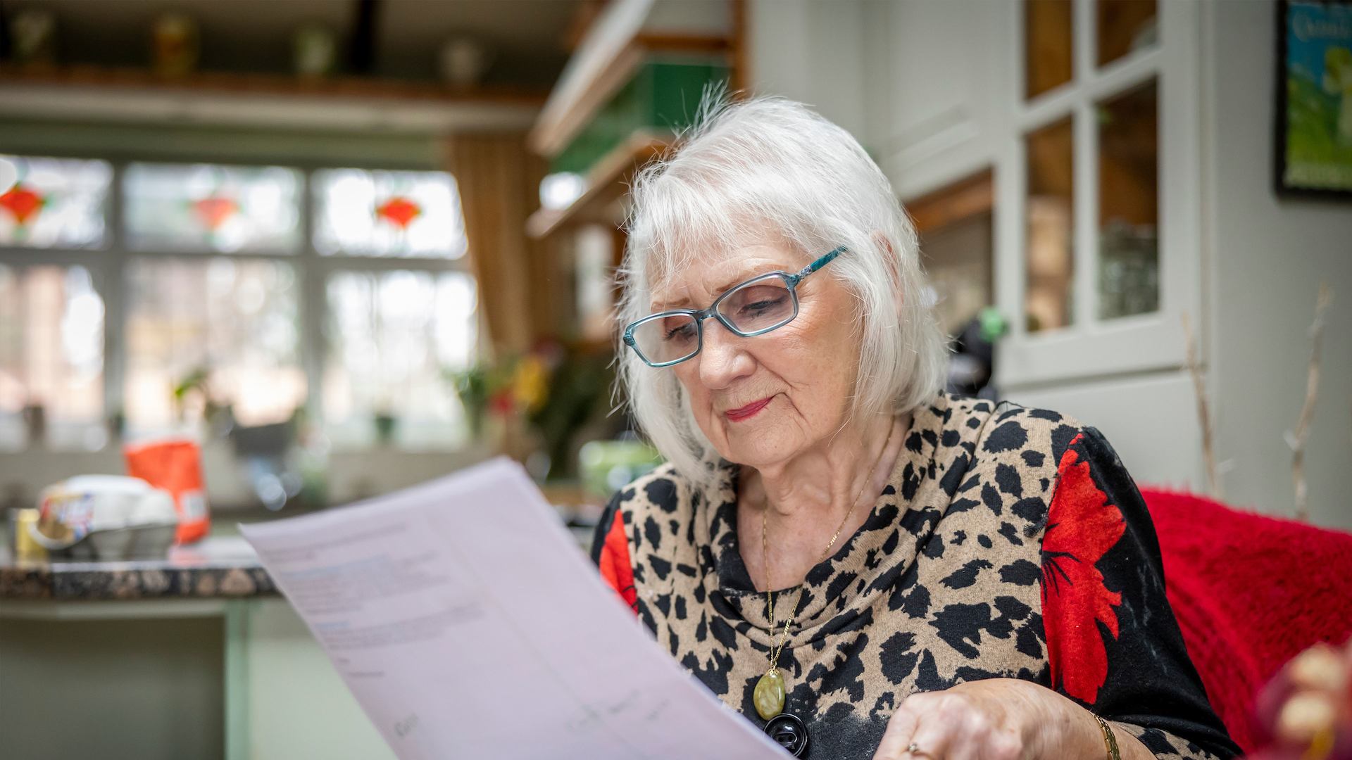 Older woman reading a bill