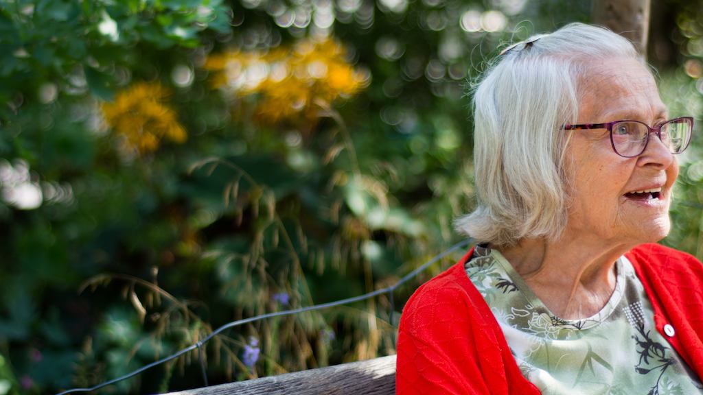 Older lady sitting in a garden