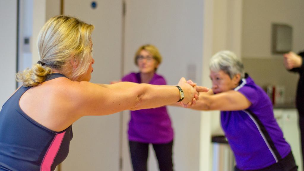 Two women stretching arms