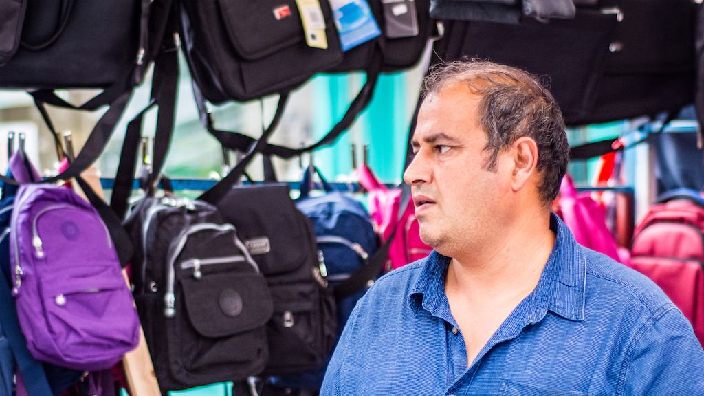 older worker selling bags