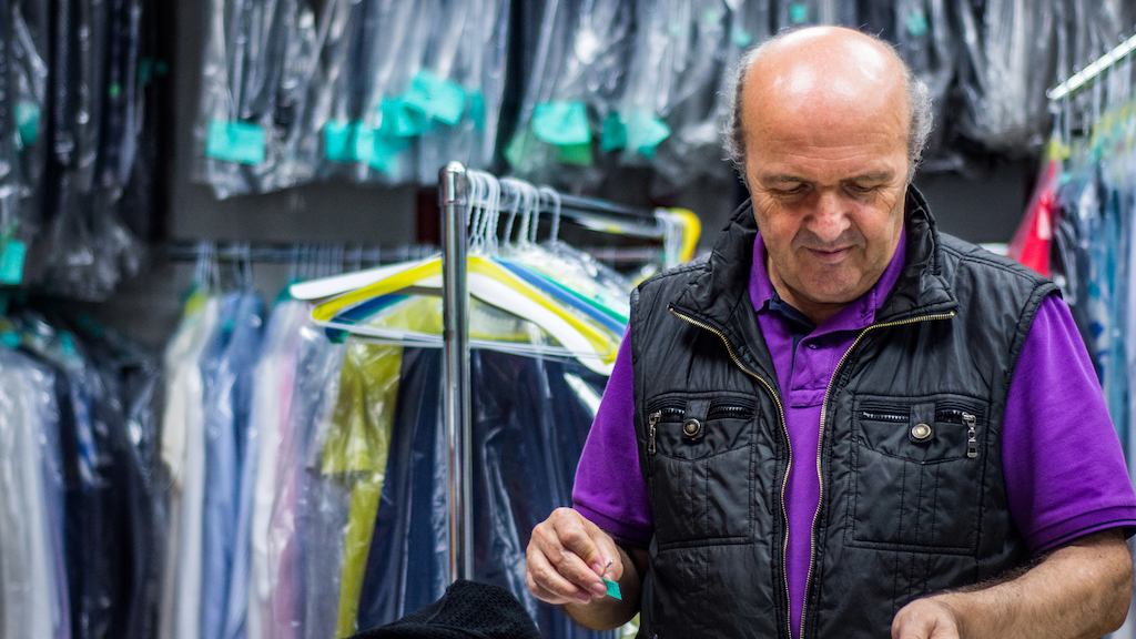 Older worker in dry cleaners