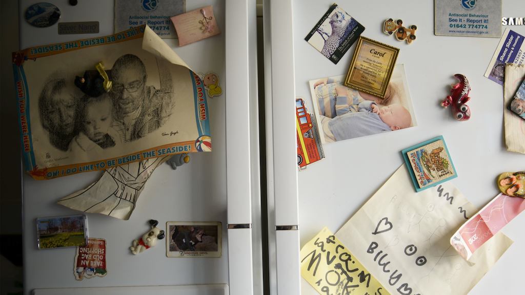 Family fridge covered in photos and magnets