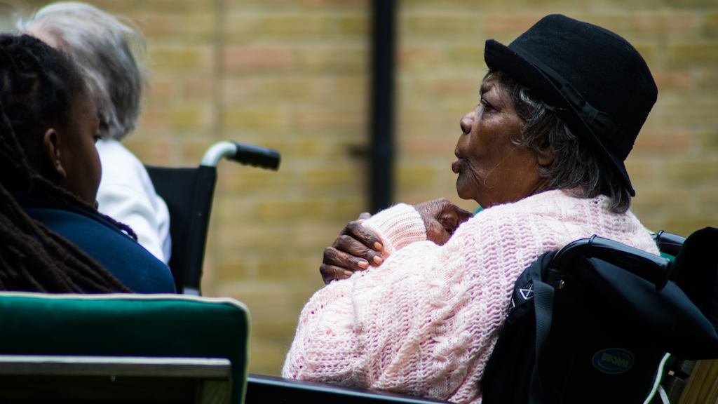 Older black woman sitting in wheelchair