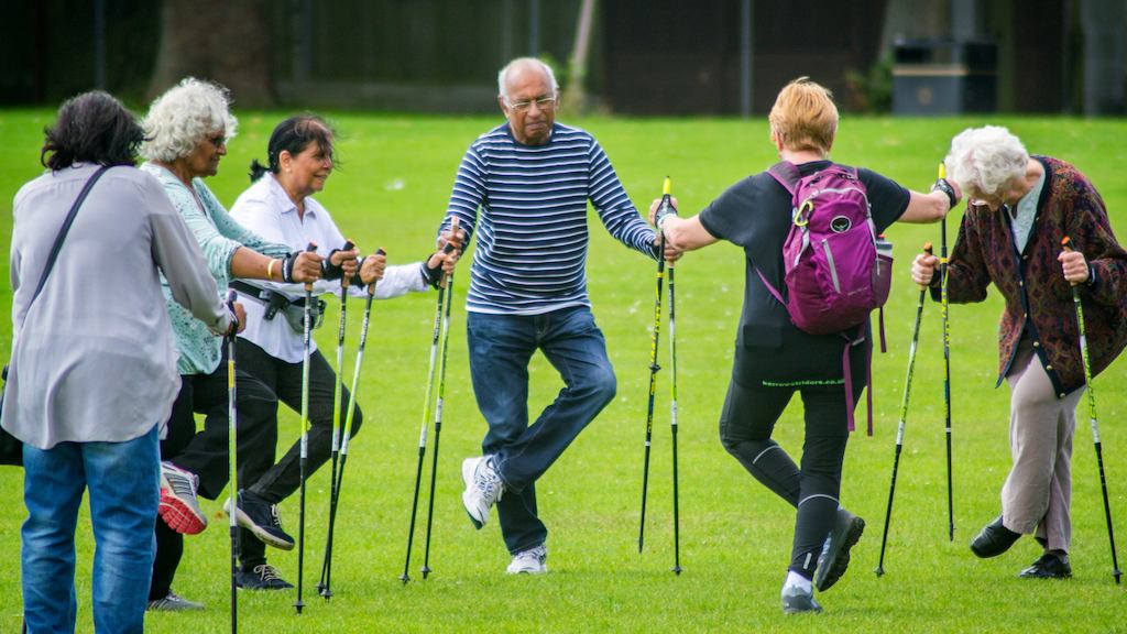 Group of people 'Nordic' walking in the park