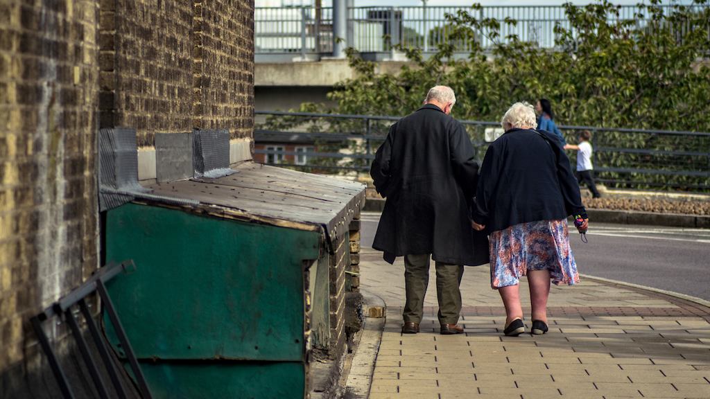 Older couple walking down street