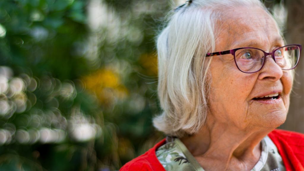 Older woman sitting on a park bench