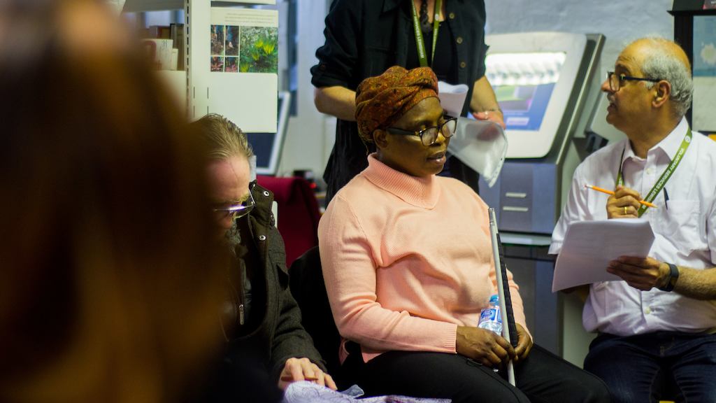 Visually impaired lady and a volunteer working through a quiz