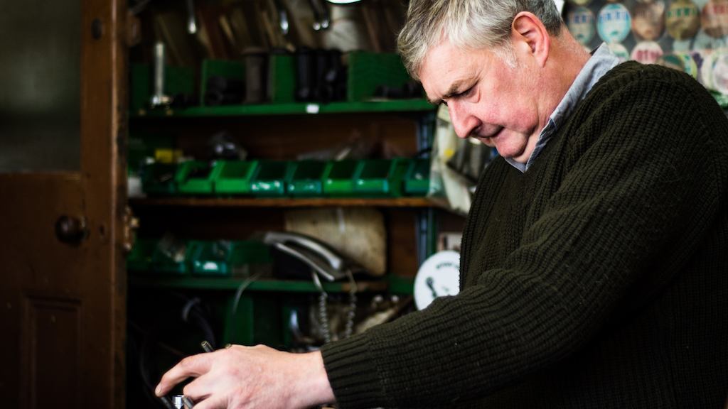 Older worker in a bike shop