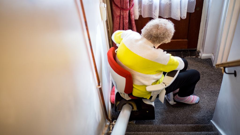 Older woman using a stairlift