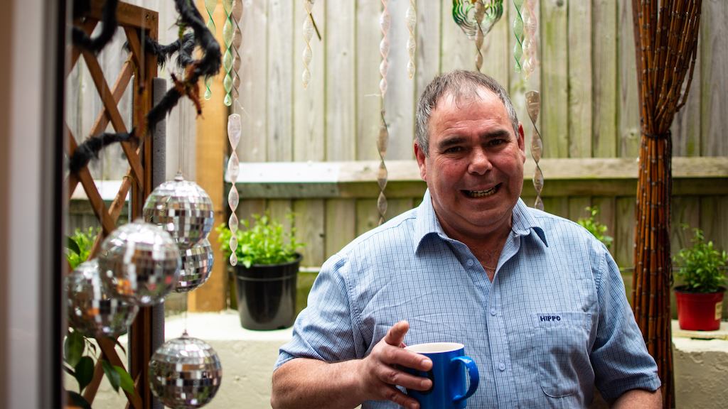 Man in a garden holding a mug of tea