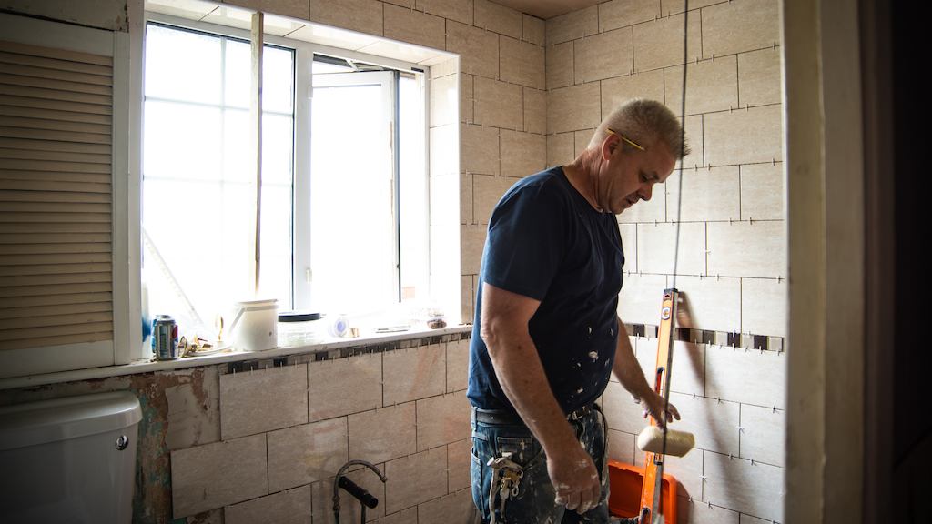 Worker making adaptations to a bathroom.