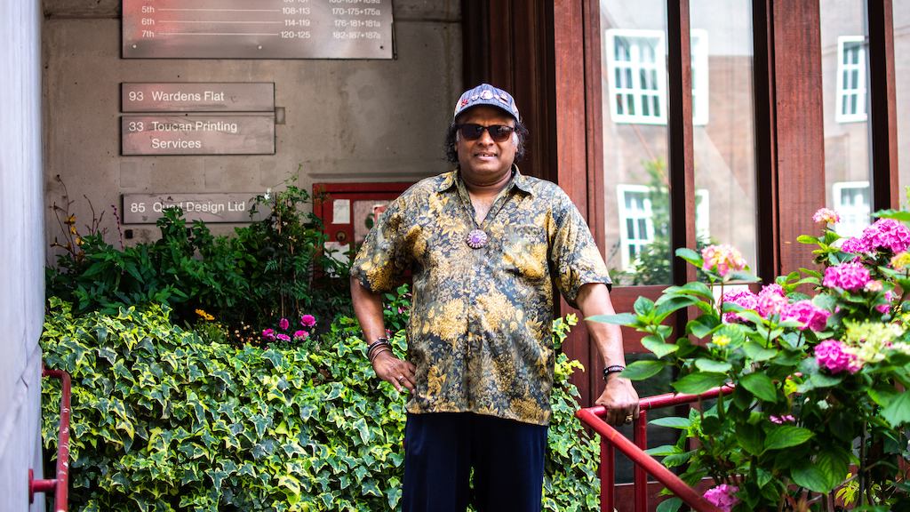 Older man standing outside in his community